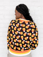 Load image into Gallery viewer, Queen Of Sparkles Black Pearl Candy Corn Cardigan with beaded orange, white and yellow candy corn and striped details on collar and sleeves
