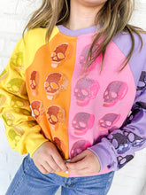 Load image into Gallery viewer, Queen of Sparkles Colorblock Multi Skull Sweatshirt with color blocking stripes of yellow, orange, pink and light purple with sequin beaded skulls