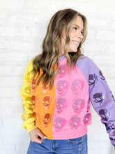 Load image into Gallery viewer, Queen of Sparkles Colorblock Multi Skull Sweatshirt with color blocking stripes of yellow, orange, pink and light purple with sequin beaded skulls