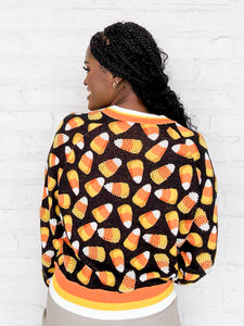 Queen Of Sparkles Black Pearl Candy Corn Cardigan with beaded orange, white and yellow candy corn and striped details on collar and sleeves