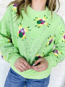 Queen Of Sparkles Neon Green Fuzzy Spider Web Sweatshirt with sequin spiders on a silver grey sparkly web