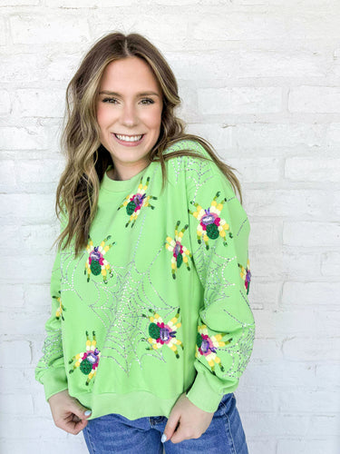 Queen Of Sparkles Neon Green Fuzzy Spider Web Sweatshirt with sequin spiders on a silver grey sparkly web