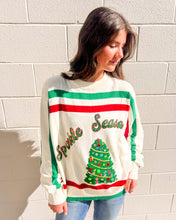 Load image into Gallery viewer, Cream sweater with red/green stripes, sequin “Sparkle Season” script and jeweled tree applique