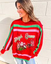 Load image into Gallery viewer, Model wearing Queen of Sparkles “Sleigh Queen” red stripe sweater with green/pink bands and sequin Santa sleigh