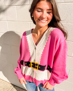 Pink Santa cardigan by Queen of Sparkles with glitter trim and belt, styled with jeans