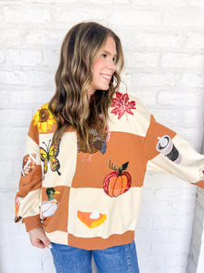 Queen Of Sparkles Checkered Fall Icon Sweatshirt with sequin icons of fall colors, pumpkin pie, butterfly and footballs