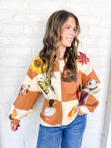 Queen Of Sparkles Checkered Fall Icon Sweatshirt with sequin icons of fall colors, pumpkin pie, butterfly and footballs