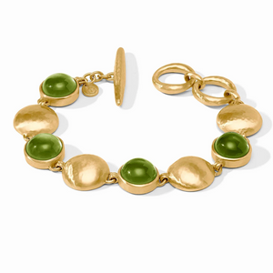Gold bracelet with green beads on a white background